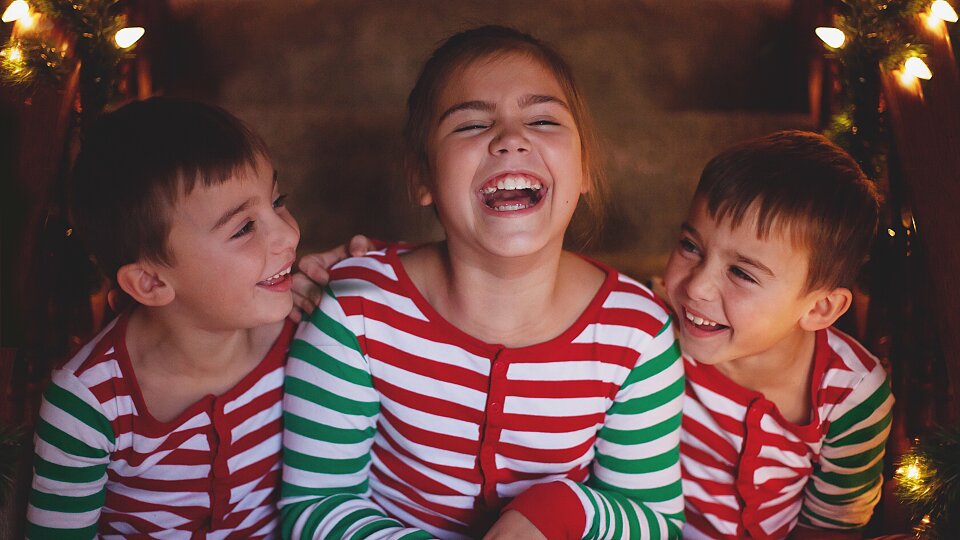 kids in christmas pajamas laughing with some light 2023 11 27 05 36 27 utc